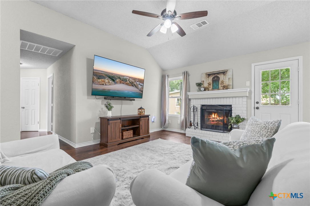 2804 Bluejay Drive Killeen, TX 76549 - Photo 7 of 36 a living room with furniture a fireplace and a flat screen tv