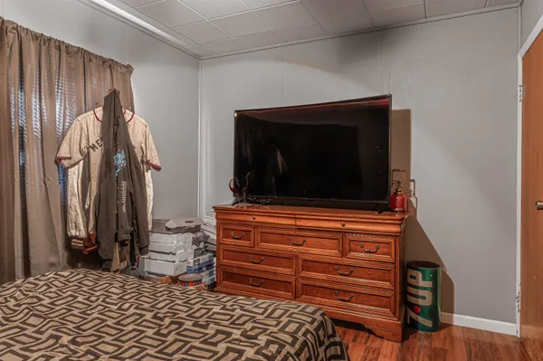 a room with a bed and a television