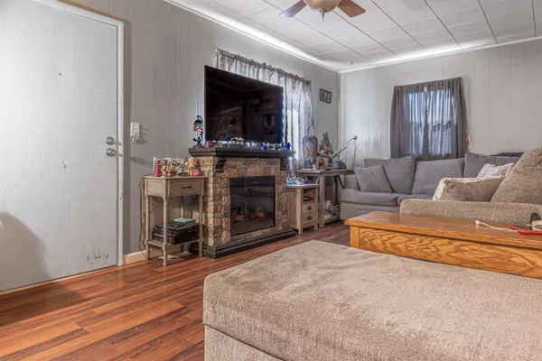 a living room with fireplace and a flat screen tv