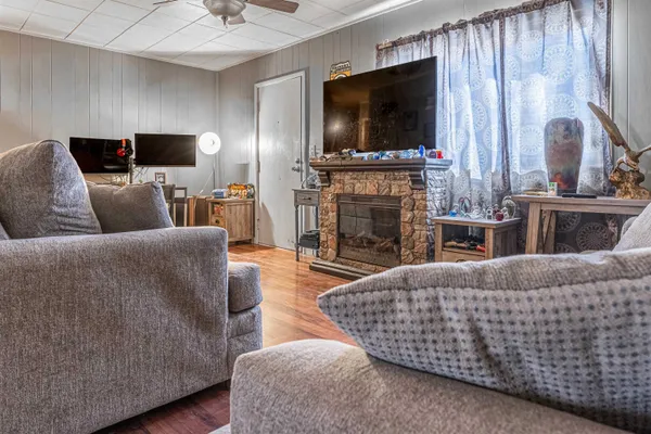 a living room with fireplace furniture and a flat screen tv