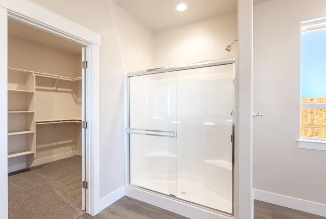 a bathroom with a glass shower door