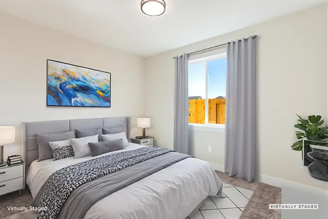 a bedroom with a bed and a painting on the wall