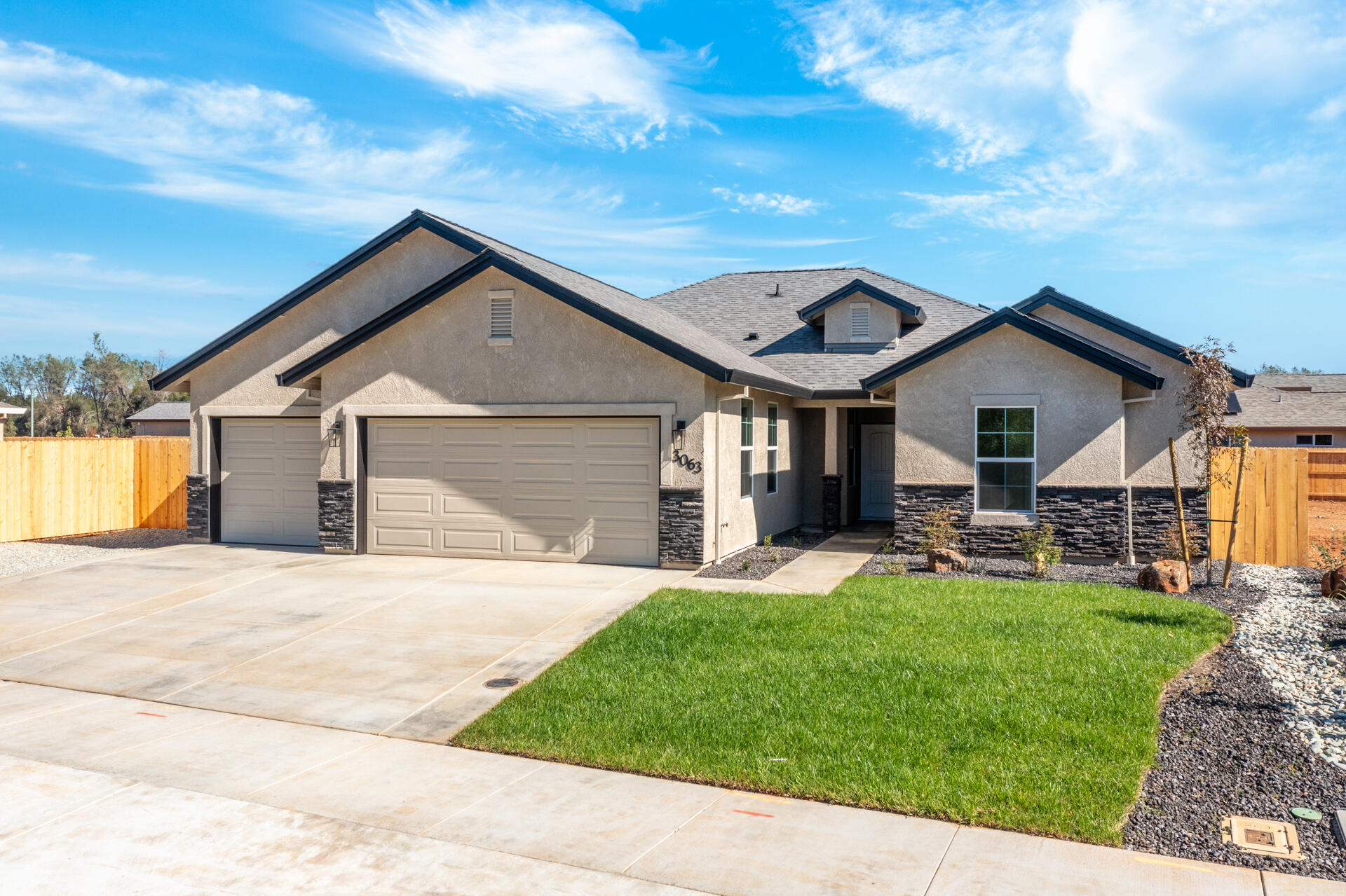 3063 Karuk Avenue Redding, CA 96002 - Photo 24 of 30 a front view of a house with a yard and garage