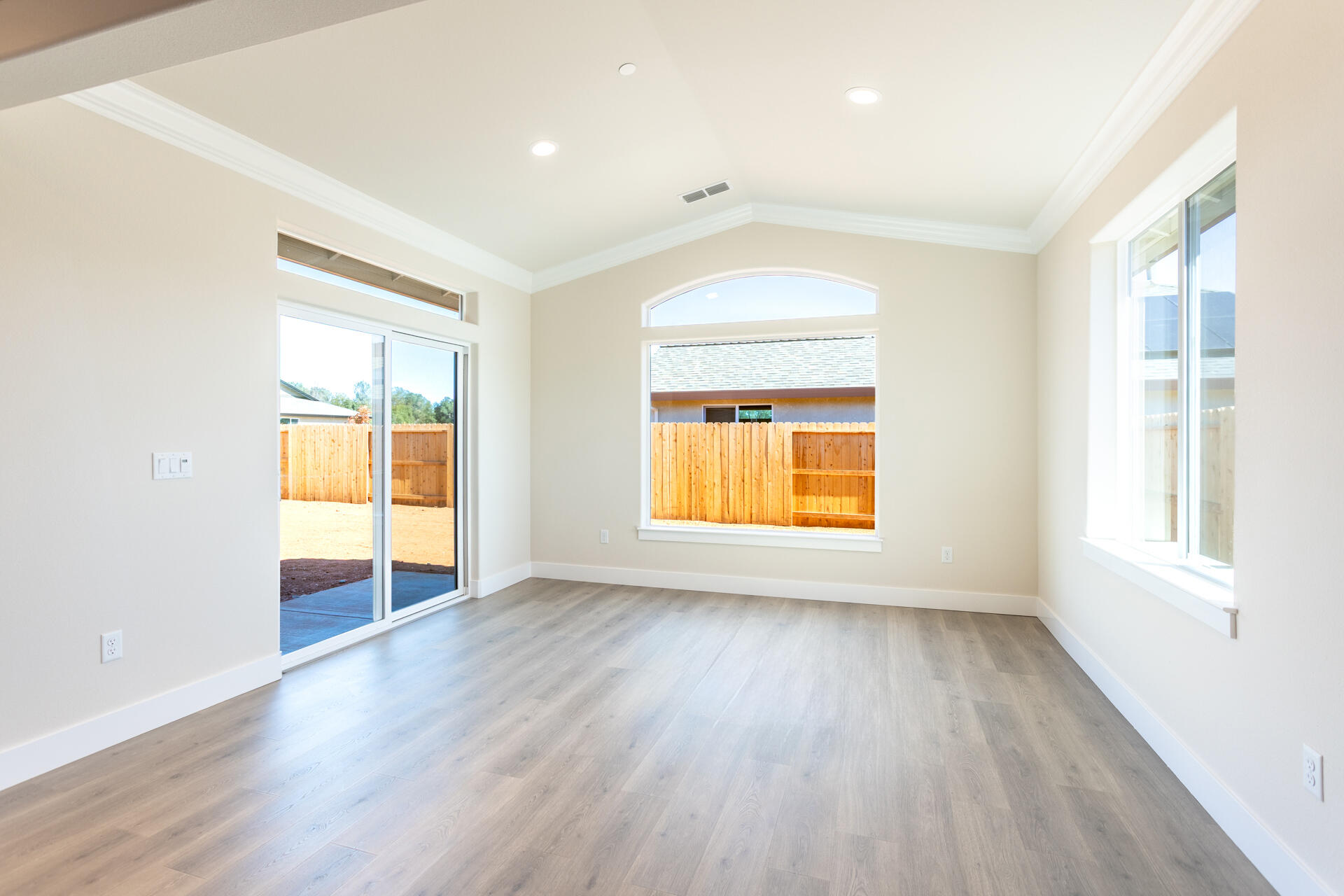 3063 Karuk Avenue Redding, CA 96002 - Photo 8 of 30 an empty room with wooden floor and windows