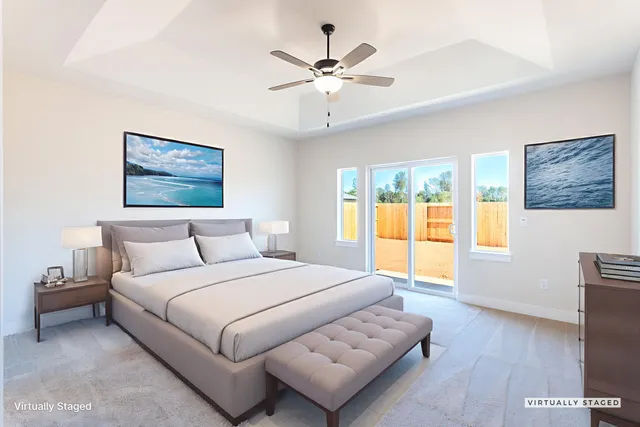 a bedroom with a bed and a large window