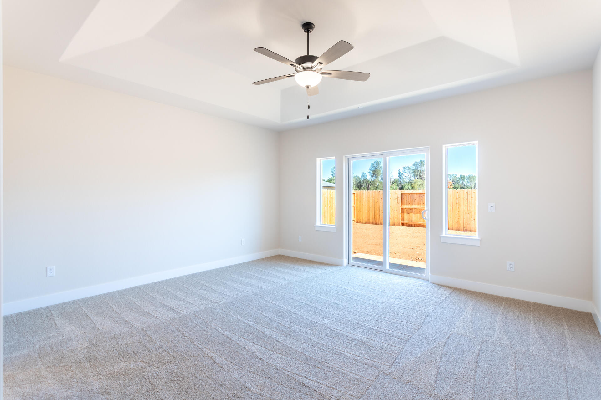3063 Karuk Avenue Redding, CA 96002 - Photo 10 of 30 an empty room with a ceiling fan and window