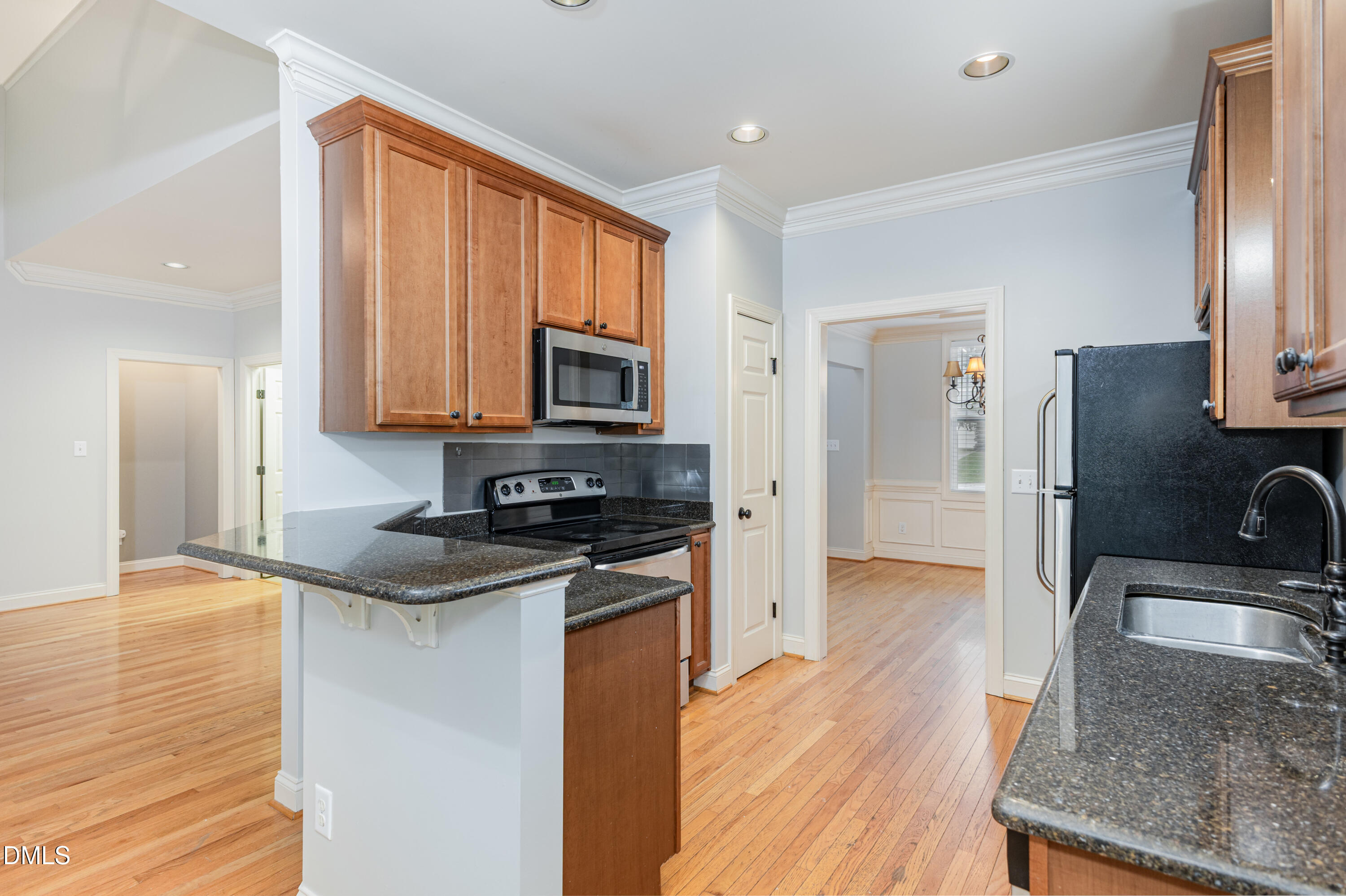 204 Blair Hills Road Wendell, NC 27591 - Photo 7 of 24 a kitchen with stainless steel appliances granite countertop a sink stove and refrigerator