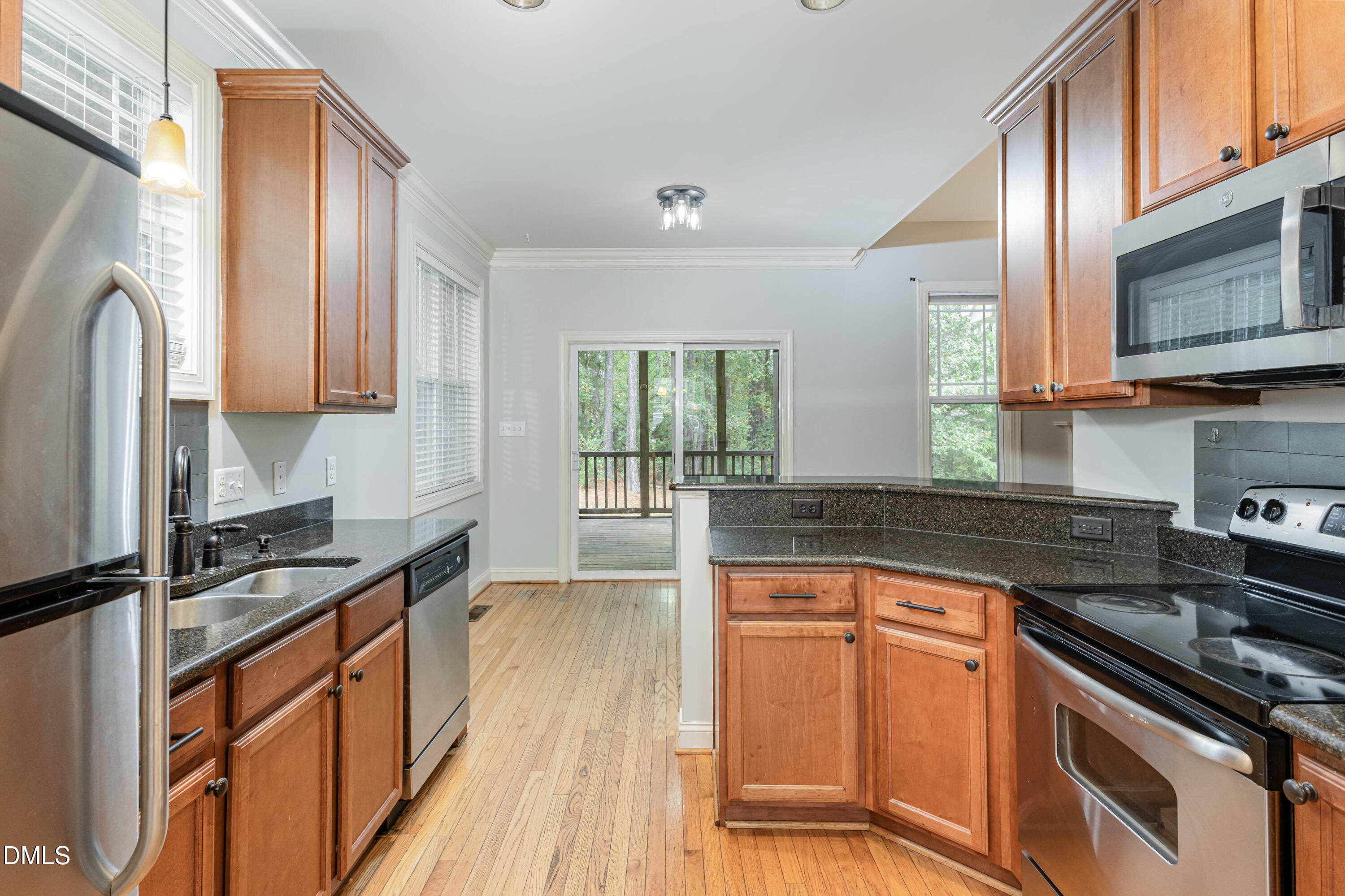 204 Blair Hills Road Wendell, NC 27591 - Photo 8 of 24 a kitchen with granite countertop a stove sink and cabinets