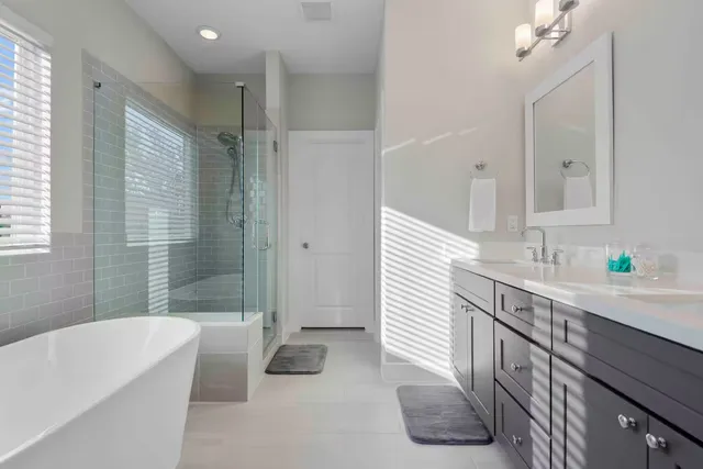a bathroom with a tub a sink and mirror