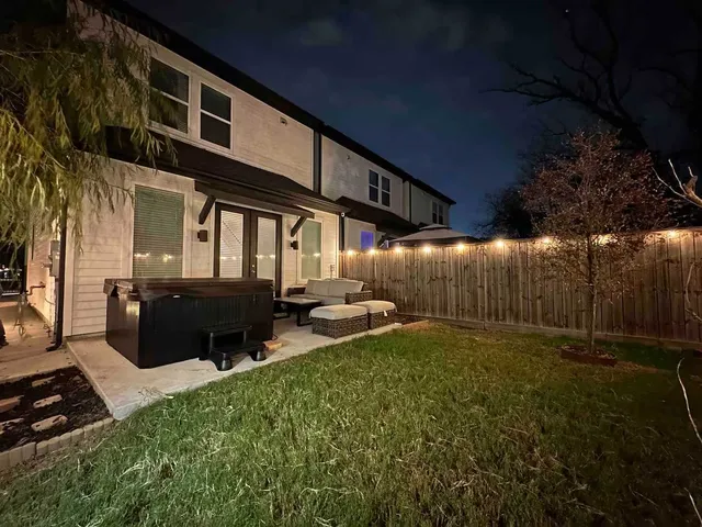 a view of a backyard with table and chairs with wooden fence
