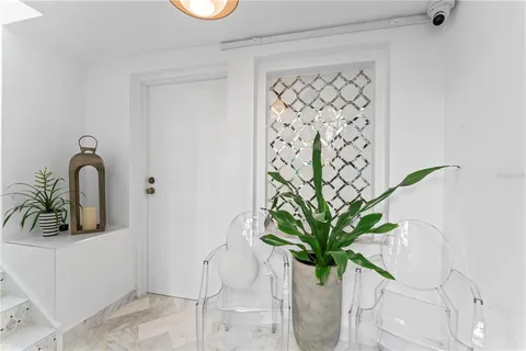 a living room with fireplace furniture and a large window