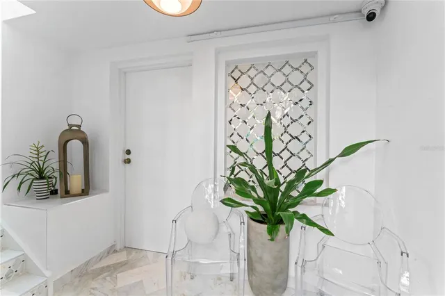 a living room with fireplace furniture and a large window