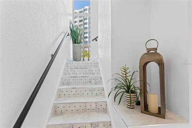 a living room with furniture a chandelier and a rug