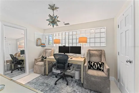 a kitchen with stainless steel appliances granite countertop a sink a stove a dining table and chairs