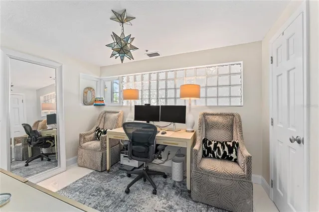 a kitchen with stainless steel appliances granite countertop a sink a stove a dining table and chairs