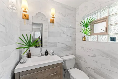 a bedroom with a balcony a bed and a chandelier