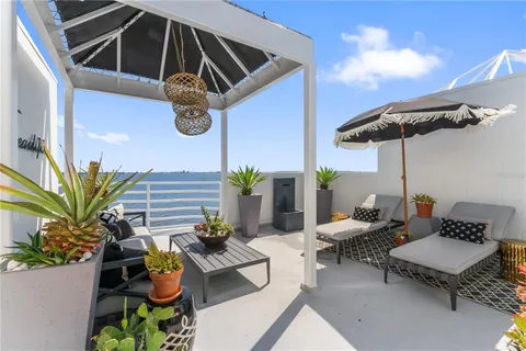 a view of a hallway with wooden floor and windows