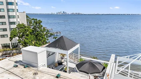 a living room with furniture potted plant and a large window