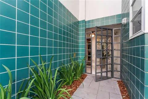 a living room with furniture a chandelier and a flat screen tv
