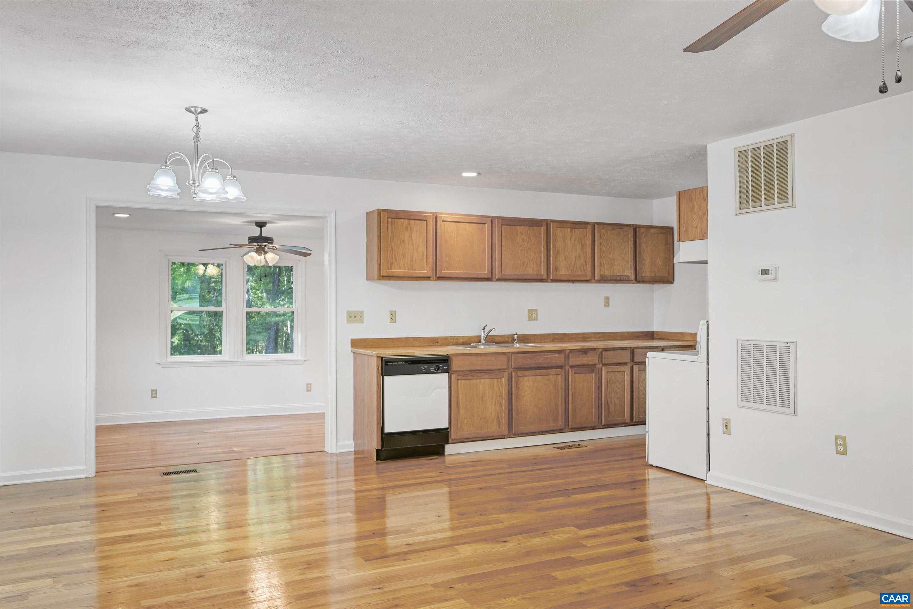 2445 Eastham Road Bumpass, VA 23024 - Photo 8 of 29 a kitchen with granite countertop a stove and a wooden floors