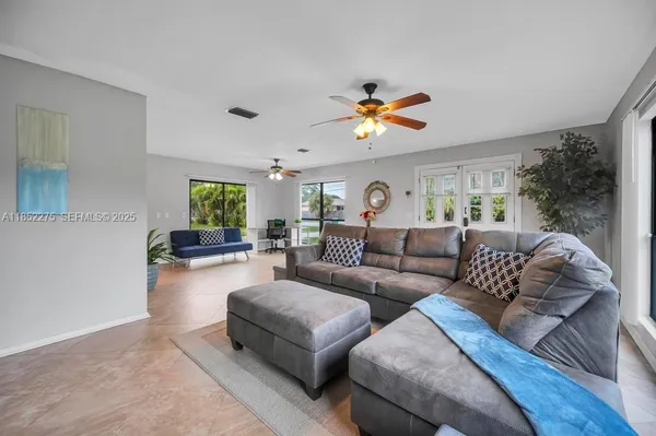 a living room with furniture and a large window