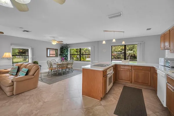 a kitchen with counter top space with furniture and window