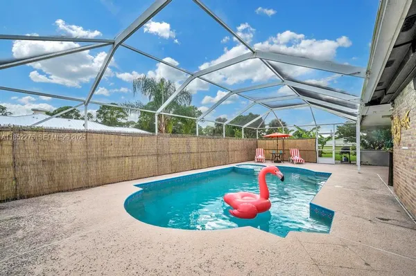 a view of a backyard with table and chairs