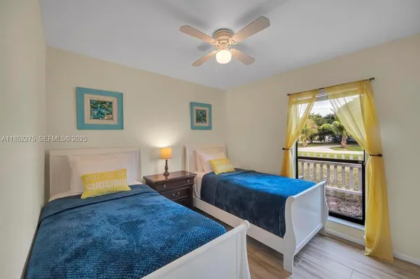 a bedroom with two beds and a window