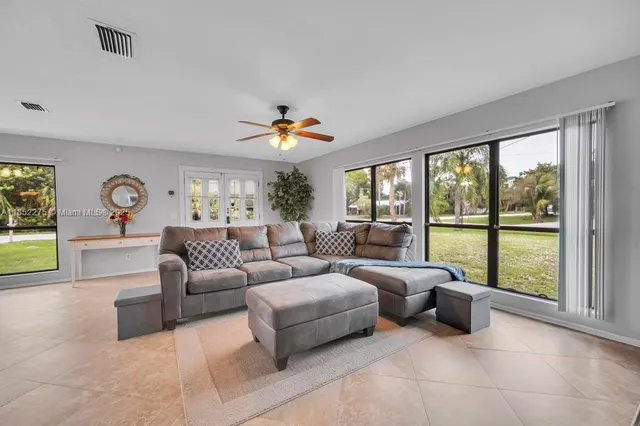 a living room with furniture and a large window