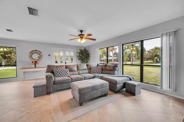 a living room with furniture and a large window