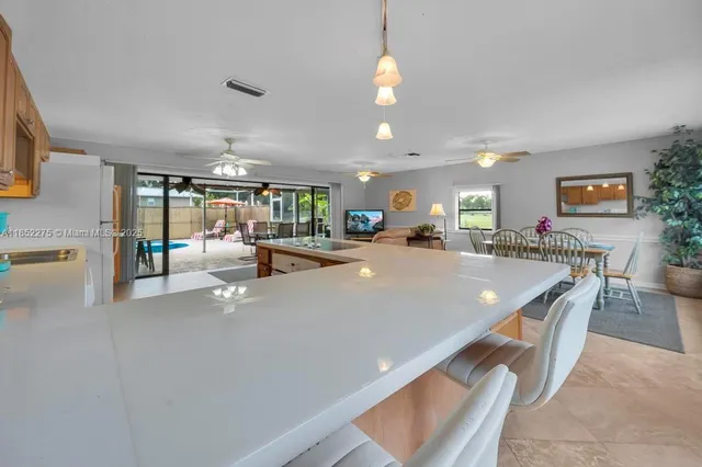 a room with lots of table chair and a view of living room