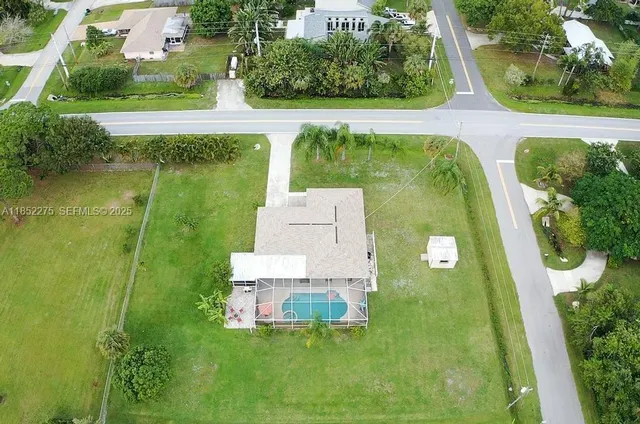 an aerial view of residential houses with outdoor space and swimming pool
