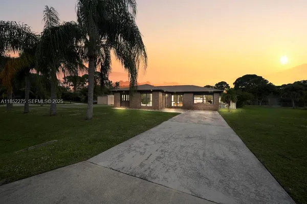 a view of house with a yard