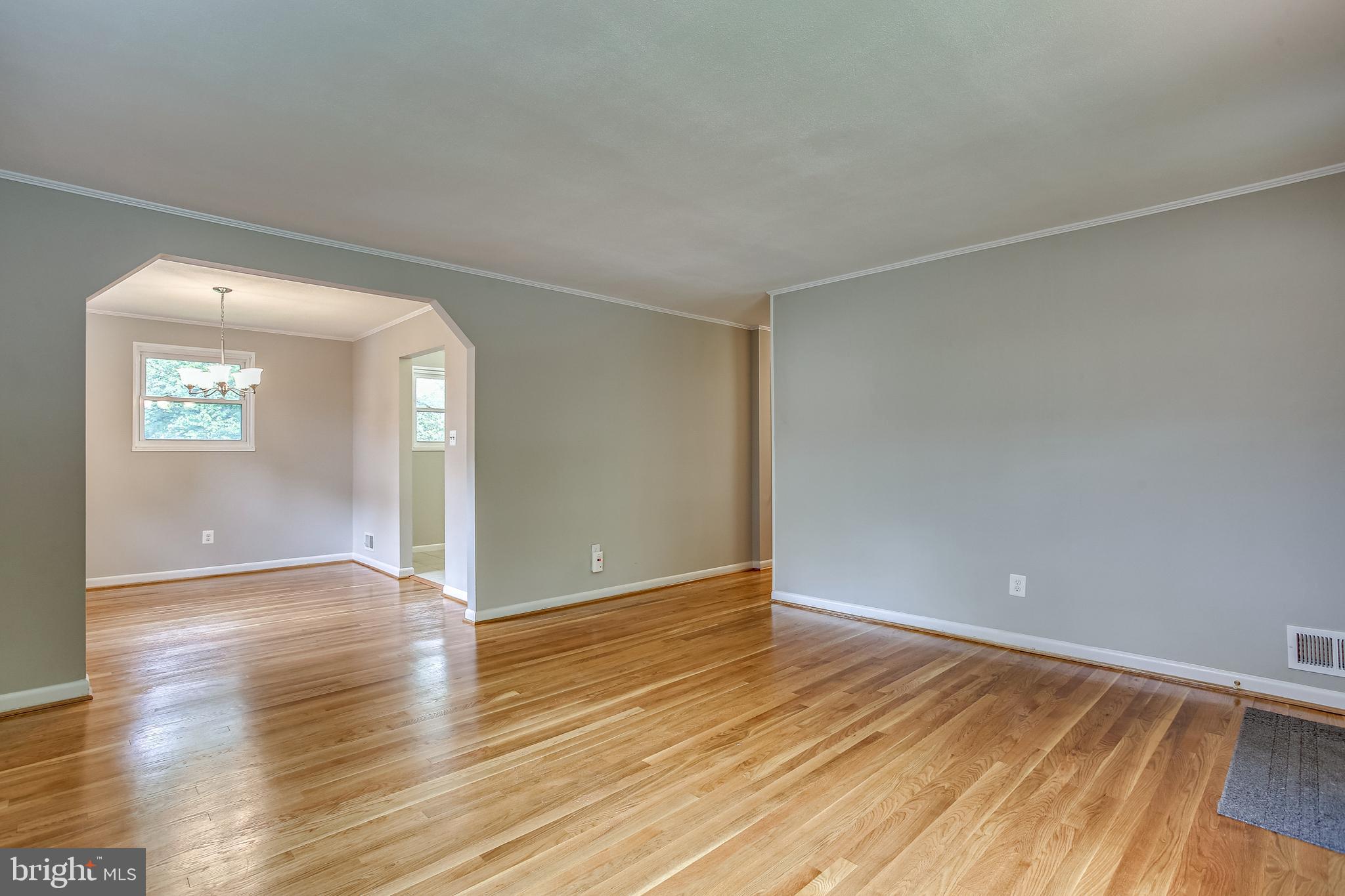 10914 Lombardy Road Silver Spring, MD 20901 - Photo 3 of 34 Living room with archway into dining room