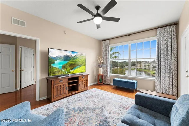 a living room with furniture and a flat screen tv