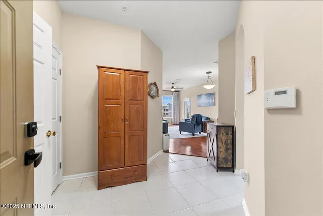 a living room with furniture a flat screen tv and kitchen view