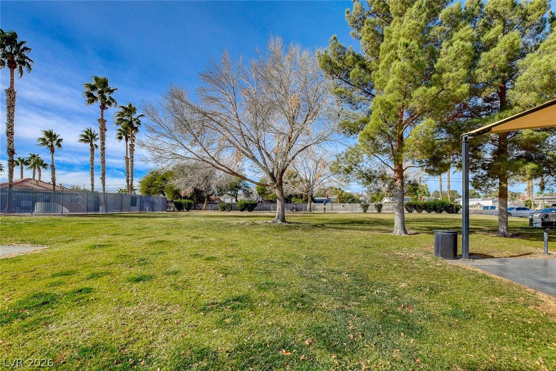 3318 North Decatur Boulevard, Unit 2072 Las Vegas, NV 89130 - Photo 38 of 50 Green space provides a tranquil setting with varied tree species and clear skies above.