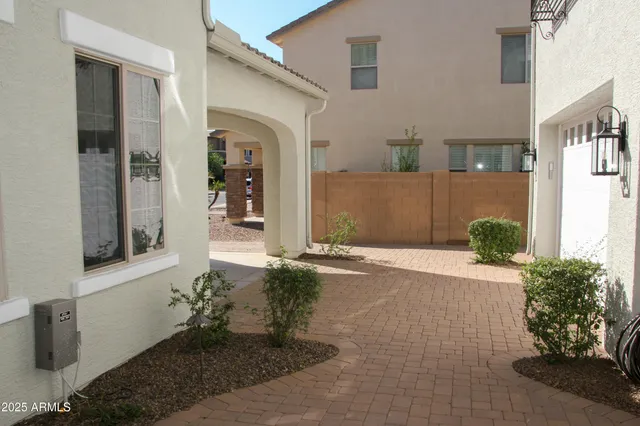 a view of a hallway with wooden floor and windows