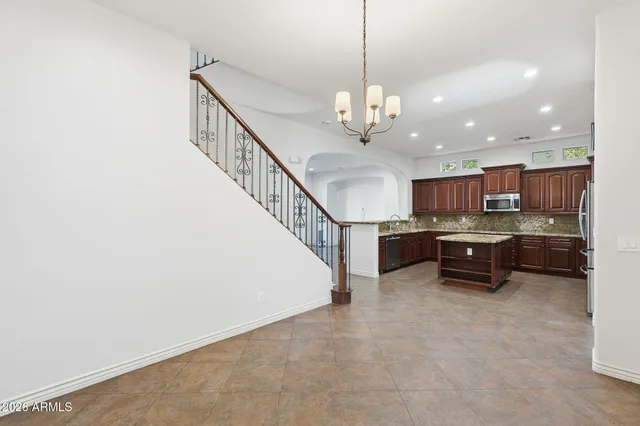 a kitchen with a stove sink and cabinets
