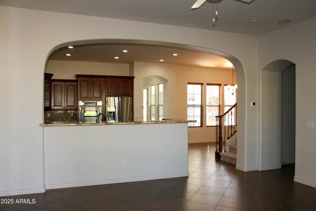 a view of a room with stairs and a floor to ceiling window