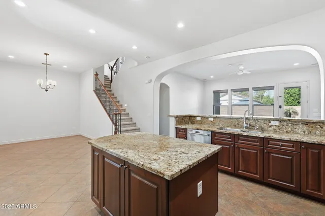 a bathroom with a double vanity sink a toilet and a tub