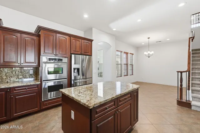 an empty room with a ceiling fan and a window