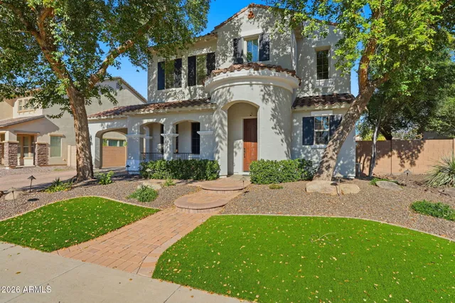 a front view of a house with a garden and plants