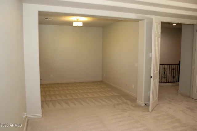 an empty room with a empty space and windows