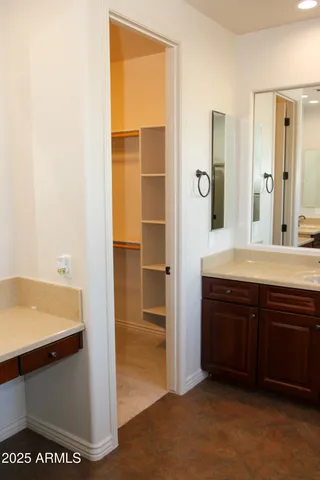 a view of a hallway to an empty room and window