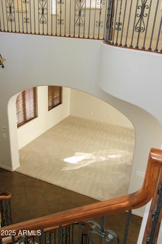 en empty room with windows and ceiling fan