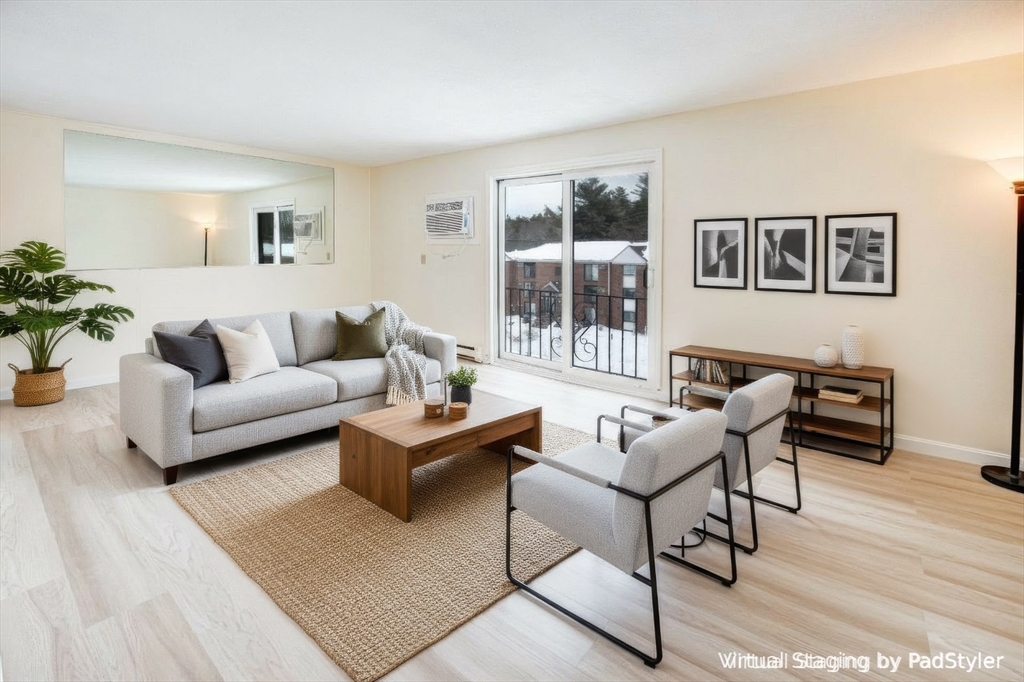 a living room with furniture and a potted plant