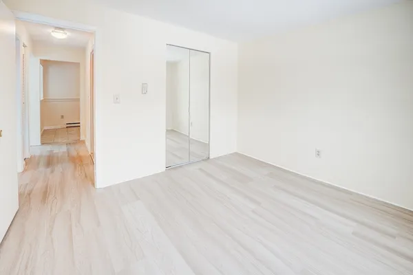 a view of a room with wooden floor