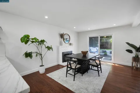 a bedroom with a bed couch and white walls