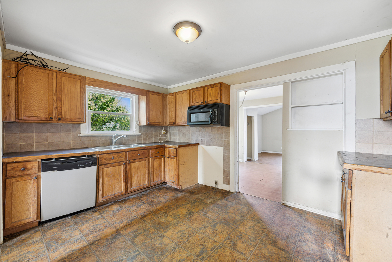208 South Park Road Joliet, IL 60433 - Photo 13 of 29 a kitchen with stainless steel appliances granite countertop a stove a sink and a refrigerator